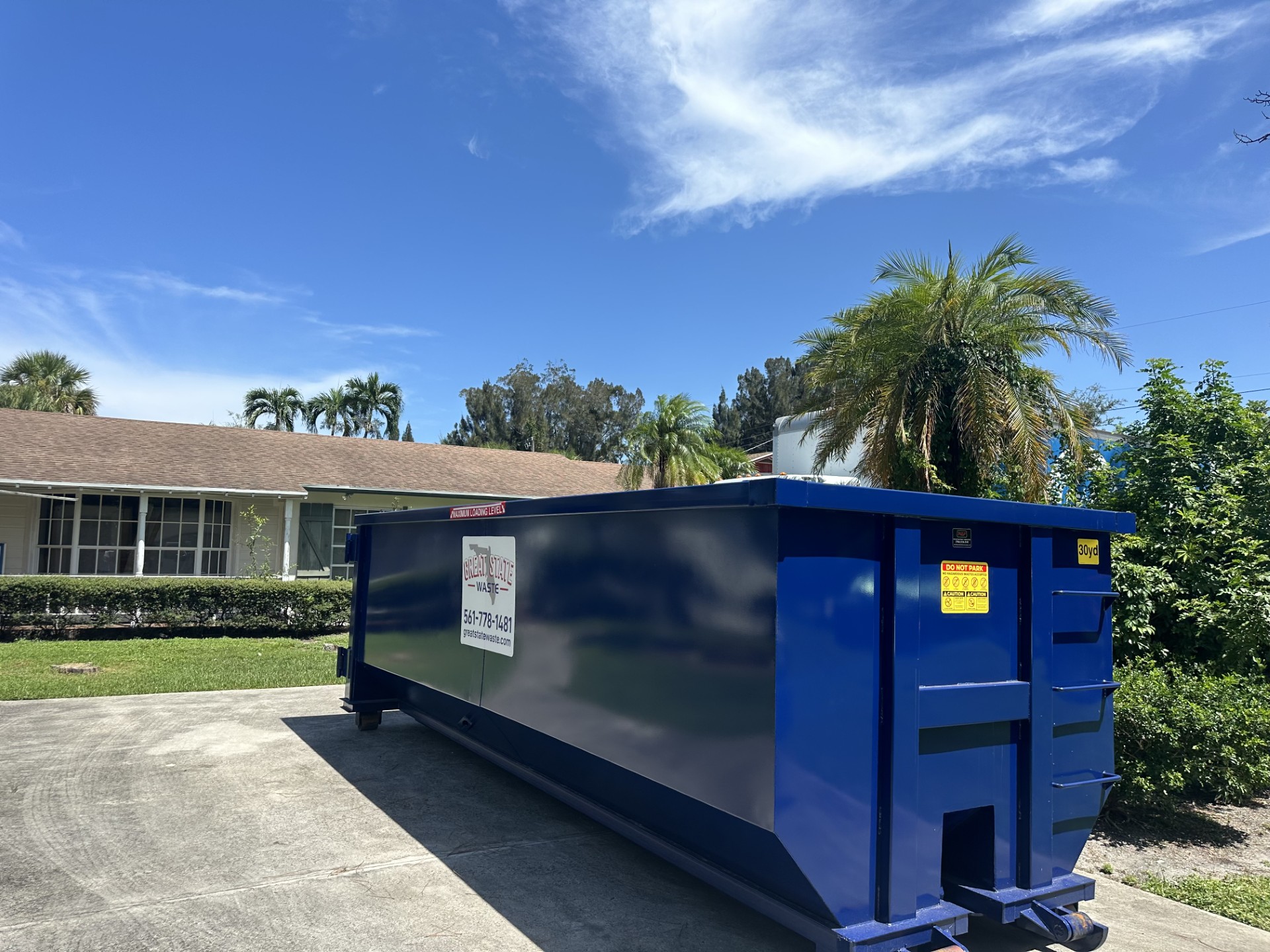 dumpster rental truck delivering container in Port St. Lucie