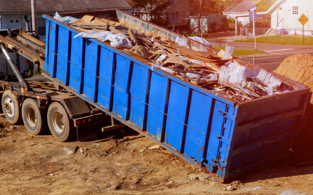 Professional rubbish removal crew clearing unwanted items from property<br />
