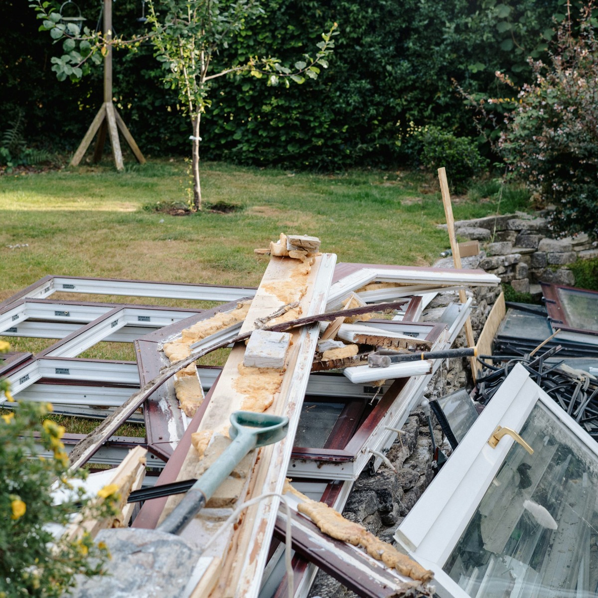 Efficient rubbish removal in North Palm Beach, FL with discarded windows, construction debris, and renovation waste ready for collection by Great State Waste.