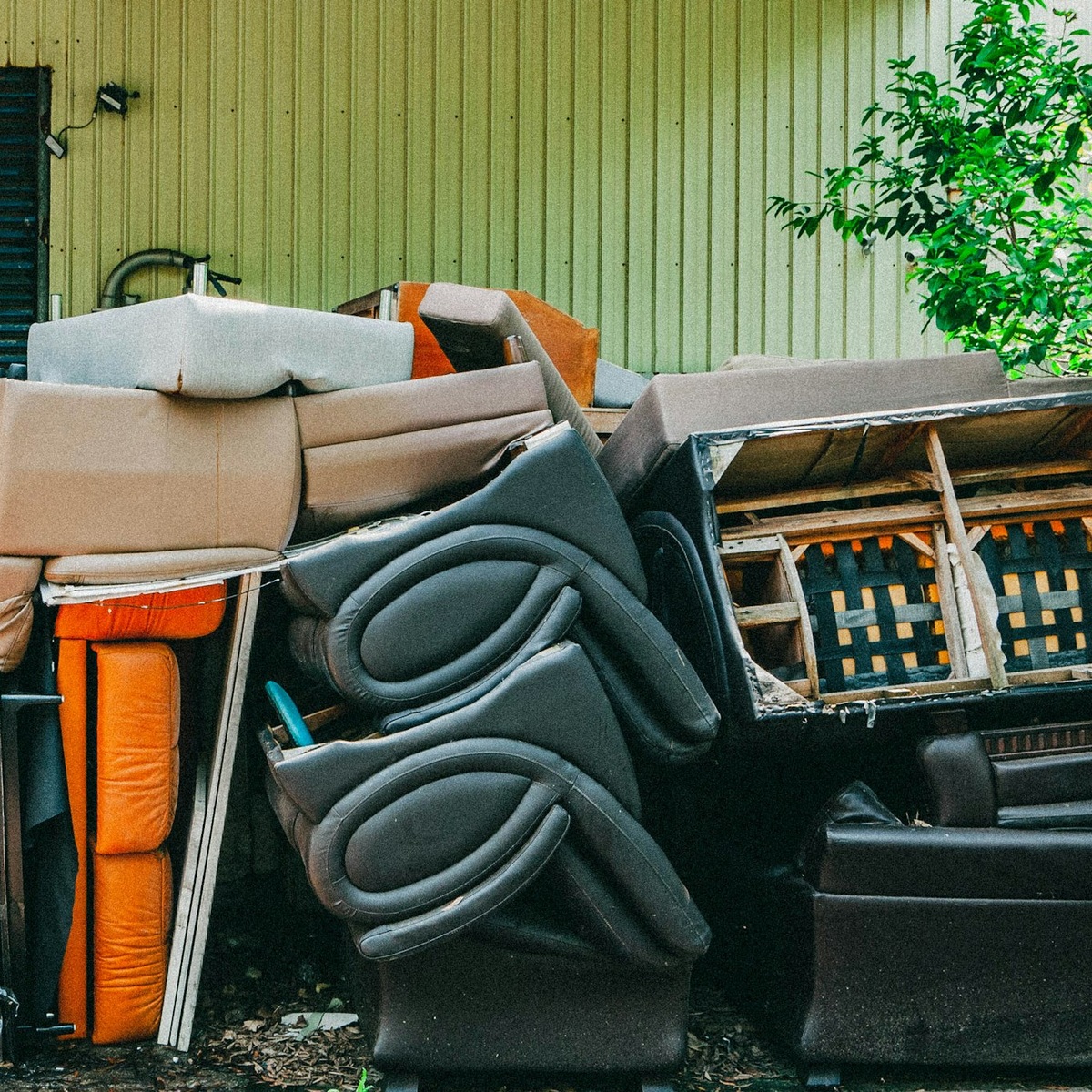 Discarded furniture and bulky household items prepared for residential dumpster disposal near me